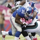 New York Giants' David Wilson (22) breaks a tackle by Philadelphia Eagles' DeMeco Ryans for a touchdown during the first half of an NFL football game Sunday, Oct. 6, 2013, in East Rutherford, N.J. (AP Photo/Kathy Willens)