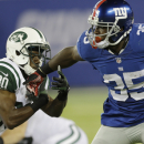 New York Giants running back Andre Brown (35) breaks a tackle by New York Jets' Darrin Walls (30) during the first half of a preseason NFL football game Saturday, Aug. 24, 2013, in East Rutherford N.J. (AP Photo/Julio Cortez)