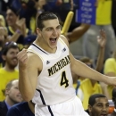 Michigan forward Mitch McGary (4) celebrate after a play during the second half of an NCAA college basketball game against Northwestern in Ann Arbor, Mich., Wednesday, Jan. 30, 2013. (AP Photo/Carlos Osorio)