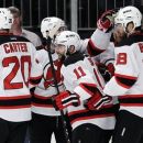 New Jersey Devils' Stephen Gionta, center, celebrates with Ryan Carter, left, and Steve Bernier, right, after scoring against the New York Rangers during the first period of Game 5 of an NHL hockey Stanley Cup Eastern Conference final playoff series Wednesday, May 23, 2012, in New York. (AP Photo/Frank Franklin II)