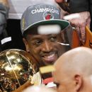 Miami Heat shooting guard Dwyane Wade embraces the the Larry O'Brien NBA Championship Trophy after Game 5 of the NBA finals basketball series against the Oklahoma City Thunder, Friday, June 22, 2012, in Miami. The Heat won 121-106 to become the 2012 NBA Champions. (AP Photo/Lynne Sladky)