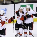 Ottawa Senators right wing Erik Condra (22) celebrates with left wing Cory Conacher (89) and center Jean-Gabriel Pageau (44) after scoring in the first period of an NHL hockey game against the Boston Bruins in Boston, Sunday, April 28, 2013. The Senators won 4-2. (AP Photo/Steven Senne)