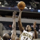 Indiana Pacers guard Paul George, right, shoots over Atlanta Hawks forward Anthony Tolliver in the second half of a preseason NBA basketball game in Indianapolis, Tuesday, Oct. 16, 2012. The Pacers won 102-98. (AP Photo/Michael Conroy)