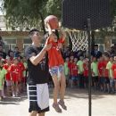 The Houston Rockets Jeremy Lin helps a child to slum a dunk during a basketball clinic at a school in Changping, on the outskirts of Beijing, Thursday, Aug. 9, 2012. (AP Photo/Andy Wong)