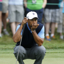 Tiger Woods reads the green on the 11th hole during the first round of the Deutsche Bank Championship golf tournament in Norton, Mass., Friday, Aug. 30, 2013. (AP Photo/Stew Milne)