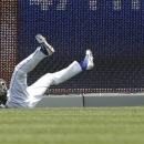 Kansas City Royals right fielder David Lough (7) lands after catching a fly ball hit by Detroit Tigers' Miguel Cabrera during the third inning of a baseball game at Kauffman Stadium in Kansas City, Mo., Wednesday, June 12, 2013. (AP Photo/Orlin Wagner)