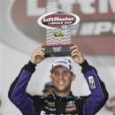 Denny Hamlin raises the trophy in victory lane after winning the pole position for Sunday's NASCAR Sprint Cup series Coca-Cola 600 auto race at Charlotte Motor Speedway in Concord, N.C., Thursday, May 23, 2013. (AP Photo/Chuck Burton)
