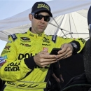 Matt Kenseth checks his phone prior to practice for Denny Hamlin's Charity Race at Richmond International Raceway in Richmond, Va., Thursday, April 25, 2013. The driver for Joe Gibbs Racing spoke out Thursday, one day after his team was slapped with some of the harshest penalties in NASCAR history because his race-winning car at Kansas last week failed post-race inspection. (AP Photo/Steve Helber)