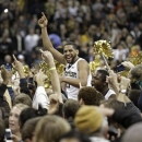 Wake Forest's C.J. Harris, center, celebrates with fans after their 80-65 win over second-ranked Miami in an NCAA college basketball game in Winston-Salem, N.C., Saturday, Feb. 23, 2013. (AP Photo/Chuck Burton)