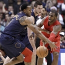Los Angeles Clippers guard Chris Paul, right, passes the ball under pressure from Denver Nuggets' Andre Iguodala (9) and Danilo Gallinari, center, during the first half of their NBA basketball game, Tuesday, Dec. 25, 2012, in Los Angeles. (AP Photo/Jason Redmond)