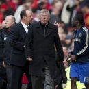 Manchester United's manager Sir Alex Ferguson, centre, passes opposing manager Rafa Benitez, second left as he walks from the pitch after his team's 1-0 loss to Chelsea during their English Premier League soccer match at Old Trafford Stadium, Manchester, England, Sunday May 5, 2013. (AP Photo/Jon Super)