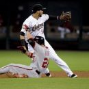 Washington Nationals' Jesus Flores (26) slides into second base ahead of the throw to Houston Astros' Marwin Gonzalez (9) for a double in the fifth inning of a baseball game, Tuesday, Aug. 7, 2012, in Houston. (AP Photo/Pat Sullivan)