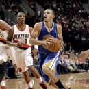 Golden State Warriors guard Stephen Curry, right, drives to the basket past Portland Trail Blazers guard Damian Lillard during the first quarter of an NBA preseason basketball game in Portland, Ore., Friday, Oct. 19, 2012. (AP Photo/Don Ryan)