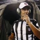 Referee Gene Steratore talks to booth officials before an NFL football game between the Baltimore Ravens and Cleveland Browns in Baltimore, Thursday, Sept. 27, 2012. (AP Photo/Patrick Semansky)