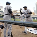 New York Yankees' Robinson Cano, right, is all smiles as he reaches the dugout after his second home run of the game in the third inning of a baseball game, Monday, July 1, 2013 in Minneapolis. (AP Photo/Jim Mone)