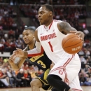 Ohio State's DeShaun Thomas (1) drives as Michigan's Trey Burke (3) tries to keep up during the first half of an NCAA college basketball game Sunday, Jan. 13, 2013 in Columbus, Ohio. Ohio State won 56-53. (AP Photo/Mike Munden)