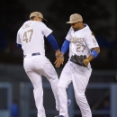 Los Angeles Dodgers' Luis Cruz, left, and Matt Kemp celebrate after they defeated the Los Angeles Angels 8-7 in their baseball game, Monday, May 27, 2013, in Los Angeles. (AP Photo/Mark J. Terrill)