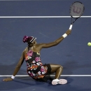 Venus Williams falls to the court as she misses a shot against Jie Zheng of China in a tie breaker during the second round of the 2013 U.S. Open tennis tournament, Wednesday, Aug. 28, 2013, in New York. (AP Photo/Darron Cummings)