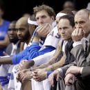Dallas Mavericks' Dirk Nowitzki, center, of Germany and coach Rick Carlisle, second from right, along with the reset of the bench look on in the final minutes of the second half of Game 3 in the first round of the NBA basketball playoffs Thursday, May 3, 2012, in Dallas. The Thunder won 95-79. (AP Photo/Tony Gutierrez)