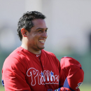 Philadelphia Phillies' Carlos Ruiz smiles as he prepares for batting practice during a workout at baseball spring training, Thursday, Feb. 21, 2013, in Clearwater, in Fla. (AP Photo/Matt Slocum)