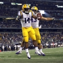 LSU running back Terrence Magee (14) celebrates scoring a touchdown with teammate Connor Neighbors (43) during the second half of an NCAA college football game against the TCU, Saturday, Aug. 31, 2013, in Arlington, Texas. (AP Photo/LM Otero)