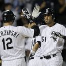 Chicago White Sox's Alex Rios (51) is greeted at home by A.J. Pierzynski, after Rios hit a three-run home run off Detroit Tigers starting pitcher Rick Porcello, Dewayne Wise and Paul Konerko scored on the home run, which was hit in the sixth inning of a baseball game Monday, Sept. 10, 2012, in Chicago. Pierzynsk followed with a solo shot. (AP Photo/Charles Rex Arbogast)