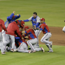 Puerto Rico players celebrate after defeating the United States 4-3 during a second-round elimination game of the World Baseball Classic, Friday, March 15, 2013, in Miami. (AP Photo/Wilfredo Lee)