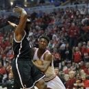 Chicago Bulls' Jimmy Butler drives to the basket against Brooklyn Nets' Reggie Evans during the first half of an NBA basketball game Saturday, April 27, 2013, in Chicago. (AP Photo/Jim Prisching)