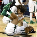 Baylor 's Brittney Griner, top, and guard Odyssey Sims, bottom, react after losing to Louisville in a regional semifinal game in the women's NCAA college basketball tournament in Oklahoma City, Sunday, March 31, 2013. Louisville won 82-81. (AP Photo/Sue Ogrocki)