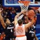 Providence's Josh Fortune (4) and Bryce Cotton 911) defend against Syracuse's Brandon Triche (20) during the first half in an NCAA college basketball game in Syracuse, N.Y., Wednesday, Feb. 20, 2013. (AP Photo/Kevin Rivoli)