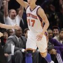 FILE - In this Feb. 10, 2012, file photo, New York Knicks' Jeremy Lin reacts after making a 3-point basket during the second half of an NBA basketball game against the Los Angeles Lakers in New York. Lin will visit the Houston Rockets on Wednesday, June 4, 2012, two people with knowledge of the plans said, and the Knicks restricted free agent is expected to get a contract offer. The Rockets waived Lin last December and he was claimed by the Knicks, turning into a breakout star when he landed the starting point guard job. Now with Goran Dragic not expected to return, Houston may want Lin back. (AP Photo/Frank Franklin II, File)