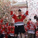 Chicago Blackhawks left wing Bryan Bickell (29) holds up the Stanley Cup Trophy during a rally in Grant Park for the NHL Stanley Cup hockey champions Friday, June 28, 2013, in Chicago. (AP Photo/Nam Y. Huh)