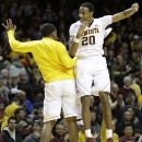 Minnesota's Austin Hollins, right, celebrates with Kendal Shell after defeating Iowa 62-59 in an NCAA college basketball game on Sunday, Feb. 3, 2013 in Minneapolis. Hollins led Minnesota, scoring with 17 points. (AP Photo/Jim Mone)
