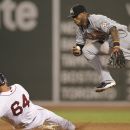 BOSTON, MA - JUNE 21:  Jose Reyes #7 of the Miami Marlins can't complete a double play over the sliding Will Middlebrooks #64 of the Boston Red Sox  during the fourth inning of the game at Fenway Park on June 21, 2012 in Boston, Massachusetts.  (Photo by Winslow Townson/Getty Images)