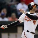 Baltimore Orioles' Nick Markakis watches his solo home run in the first inning of the first baseball game of a doubleheader against the Texas Rangers in Baltimore, Thursday, May 10, 2012. (AP Photo/Patrick Semansky)