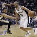 San Antonio Spurs' Tony Parker (9), of France, is defended by Utah Jazz's Devin Harris, left, during the third quarter of Game 1 of a first-round NBA basketball playoff series on Sunday, April 29, 2012, in San Antonio.  San Antonio won 106-91. (AP Photo/Eric Gay)