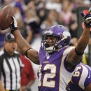 Minnesota Vikings wide receiver Percy Harvin (12) celebrates after making a touchdown in the first half of an NFL football game against the Arizona Cardinals in Minneapolis, Sunday, Oct. 21, 2012. (AP Photo/Andy King)