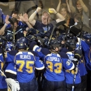 St. Louis Blues players celebrate their 2-1 overtime win over the Los Angeles Kings in Game 1 of their first-round NHL hockey Stanley Cup playoff series, Tuesday, April 30, 2013, in St. Louis. (AP Photo/Bill Boyce)