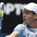 Tomas Berdych of the Czech Republic looks at a ball to return to Bernard Tomic of Australia during their fourth round match at the Australian Open tennis championship in Melbourne, Australia, Sunday, Jan. 25, 2015. (AP Photo/Andy Brownbill)