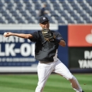 New York Yankees' Derek Jeter throws after fielding a grounder during batting practice before the Yankees' baseball against the Tampa Bay Rays at Yankee Stadium on Friday, July 26, 2013, in New York. (AP Photo/Kathy Kmonicek)
