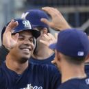 Milwaukee Brewers third baseman Aramis Ramirez is congratulated by teammates after scoring on a single by Rickie Weeks during the second inning of their baseball game against the Los Angeles Dodgers, Thursday, May 31, 2012, in Los Angeles.  (AP Photo/Mark J. Terrill)