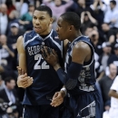 Georgetown's Otto Porter Jr., left, and Georgetown's Aaron Bowen right celebrate their double overtime win in an NCAA college basketball game against Connecticut in Storrs, Conn., Wednesday, Feb. 27, 2013. Georgetown won 79-78. (AP Photo/Jessica Hill)
