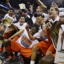 Syracuse players and coaches celebrate for photographers after their 55-39 win over Marquette in the East Regional final in the NCAA men's college basketball tournament, Saturday, March 30, 2013, in Washington. (AP Photo/Pablo Martinez Monsivais)