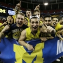 Michigan fans cheer before the first half of the NCAA Final Four tournament college basketball championship game against the Louisville, Monday, April 8, 2013, in Atlanta. (AP Photo/Charlie Neibergall)