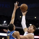Los Angeles Clippers' Blake Griffin, right, shoots over New Orleans Hornets forward Anthony Davis during the first half of an NBA basketball game in Los Angeles, Wednesday, Dec. 19, 2012. (AP Photo/Chris Carlson)