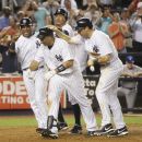 New York Yankees' Raul Ibanez, second from left, is greeted by Robinson Cano, left, Alex Rodriguez, second from right, and Mark Teixeira after he hit a grand slam during the eighth inning of the baseball game against the Toronto Blue Jays Monday, July 16, 2012 at Yankee Stadium in New York.  (AP Photo/Seth Wenig)