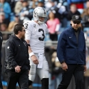 Oakland Raiders' Carson Palmer (3) walks off the field after being injured during the first half of an NFL football game against the Carolina Panthers in Charlotte, N.C., Sunday, Dec. 23, 2012. (AP Photo/Bob Leverone)