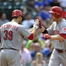 Cincinnati Reds' Devin Mesoraco (39) congratulates Todd Frazier after his solo home run against the Chicago Cubs during the seventh inning of a baseball game on Wednesday, June 12, 2013, in Chicago. (AP Photo/Jim Prisching)