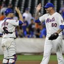 New York Mets pitcher Jon Rauch (60) celebrates with catcher Rob Johnson after the Mets defeated the Atlanta Braves, 6-5, in a baseball game Sunday, Aug. 12, 2012, at Citi Field in New York. (AP Photo/Bill Kostroun)