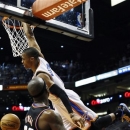 Oklahoma City Thunder's Russell Westbrook, right, dunks over Phoenix Suns' Jermaine O'Neal (20) during the first half in an NBA basketball game, Sunday, Feb. 10, 2013, in Phoenix. (AP Photo/Ross D. Franklin)